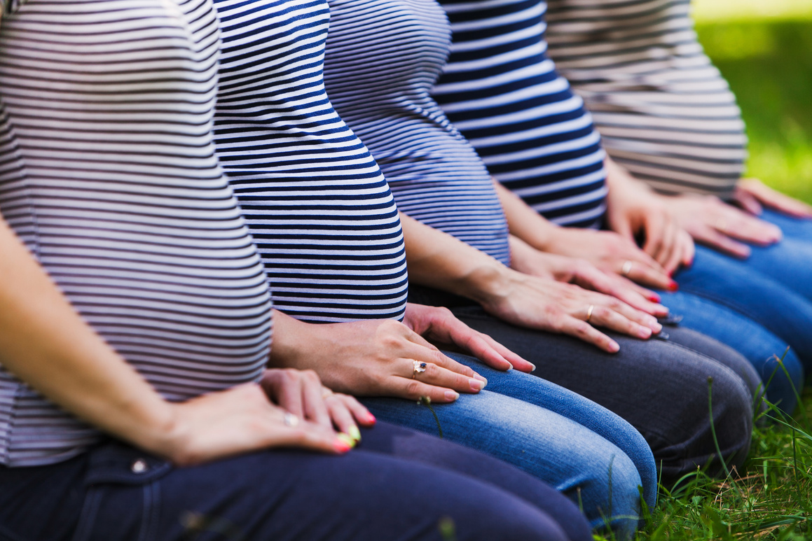 Closeup of group pregnant bellies. Pregnant women wearing the same